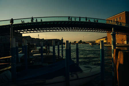 VENICE, ITALY - nov, 2021 cargo boat under the Ponte della Costituzione bridge at sunset. High quality photoのeditorial素材