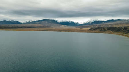dramatic and moody sky on a tranquil lake and majestic mountain peaks in Kenai Peninsula in Alaska. High quality photoの写真素材