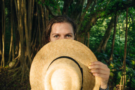 beautiful girl with hat in the jungle at sunset. High quality photoの写真素材