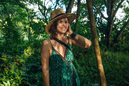 beautiful girl with hat in the jungle at sunset. High quality photoの写真素材