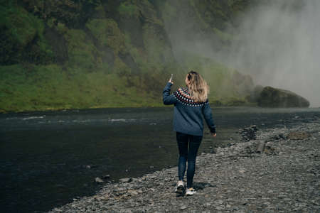 The Skogarfoss waterfall in southern Iceland with tourists. High quality photoの写真素材