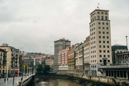Residential houses at embankment of Ibaizabal river. Bilbao, Spain - dec, 2021. High quality photoのeditorial素材