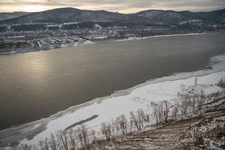 Awesome winter landscape. Top view of the Yenisey River among scenic mountains covered with snow, Siberia. high quality photoの写真素材