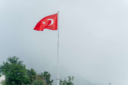Turkish flag in the fog in Kas, Turkey. high quality photoの写真素材