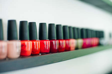 usa, la - january, 2020 colorful nail polish colors in a row at nails saloon on white background.のeditorial素材