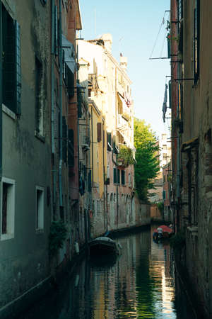 Italy - nov, 2021. The cityscape and architecture of Venice. Urban canal and boats on it. high quality photoのeditorial素材