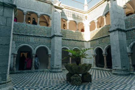 Sintra, Portugal - Dec, 2021: Pena National Palace seen from Castle of the Moors with tourists. high quality photoのeditorial素材