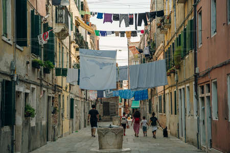 non tourist street in venice, italy. laundry hanging over the street. high quality photoのeditorial素材
