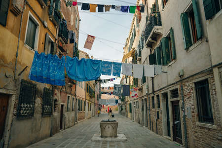 non tourist street in venice, italy. laundry hanging over the street. high quality photoのeditorial素材