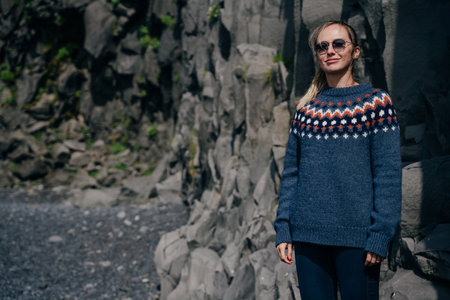 girl in a sweater on the background of the mountains in iceland. high quality photoの写真素材