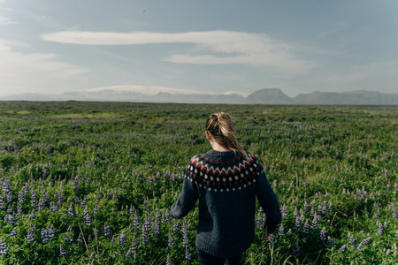 girl in a sweater on the background of the mountains in iceland. high quality photoの写真素材