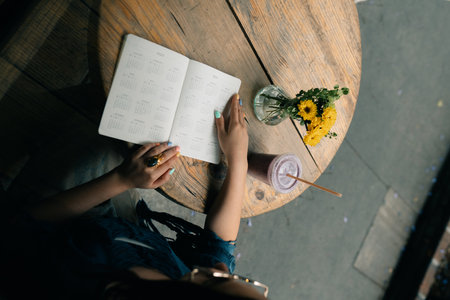 young girl at a table in a cafe with a notebook. high quality photoの写真素材