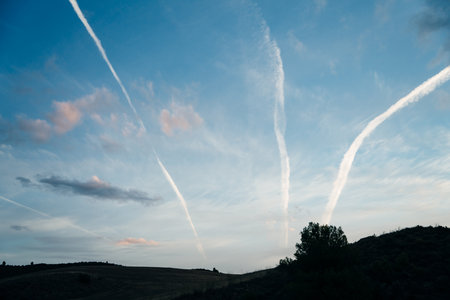 contrails of aircraft against a blue sky. routes in airways. high quality photoの写真素材