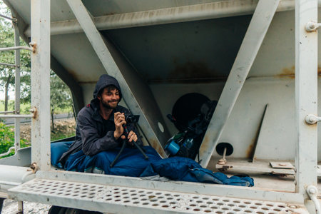 hobo bloggers climbing freight train with cameras. High quality photoの写真素材