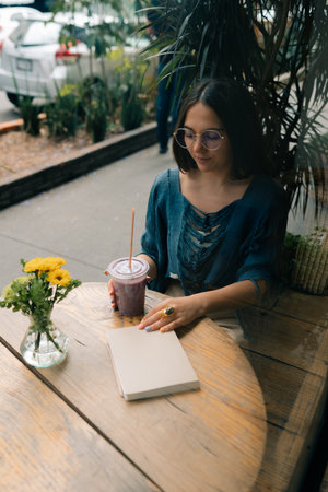 girl drinking smoothies in a cafe. High quality photoの写真素材