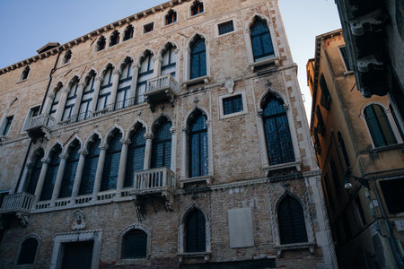 View of old narrow street in Venice, Italy. Architecture and landmark of Italy. Cozy cityscape of Rome. high quality photoのeditorial素材