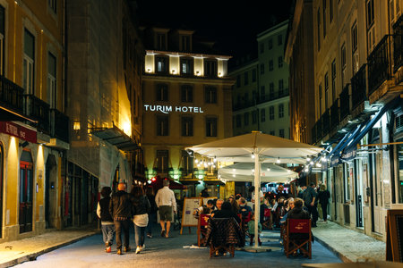 People walking in Lisbon at night. Portugal - May 2023. High quality photoのeditorial素材