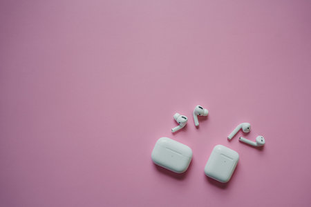 Air Pods 3. Air Pods 2021. with Wireless Charging Case. Magsafe. New Airpods on pink background. high quality photoのeditorial素材