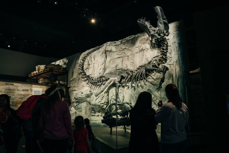 Drumheller, Canada - Mar 2023 Visitors flock to the dinosaur exhibits at the entrance of the Royal Tyrrell Museum. high quality photoのeditorial素材