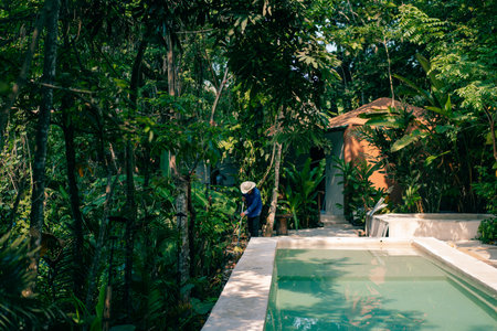 man cleaning next to the pool. high quality photo