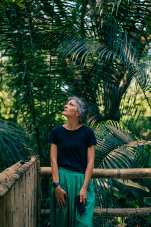 girl stands on the background of tropical trees. high quality photoの写真素材