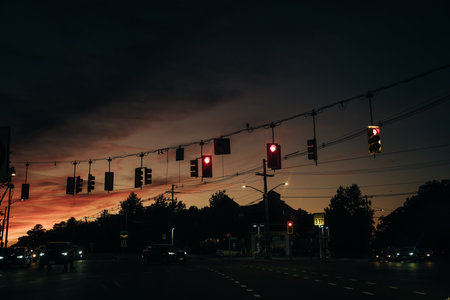 Silhouette of red traffic lights against small clouds in sunset. high quality photo