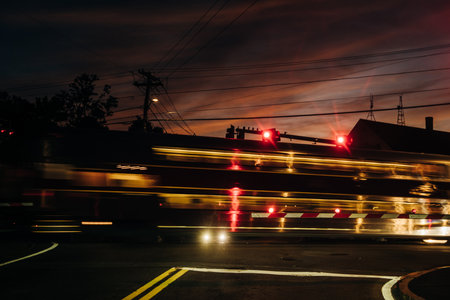 Silhouette of red traffic lights against small clouds in sunset. high quality photoの写真素材