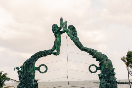 PLAYA DEL CARMEN, MEXICO - may 2023 Visitors mingling with performers under the Portal Maya sculpture. High quality photoのeditorial素材