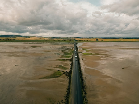 The causeway to Holy Island photographed with a spectacular Sunrise. High quality photoの写真素材
