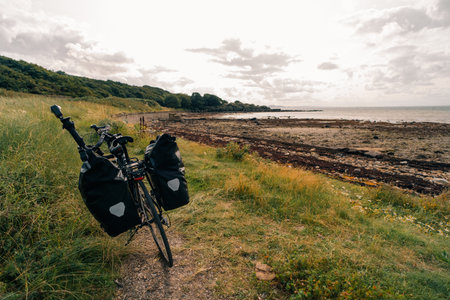 Traveler on bicycle. Solo travel long distance bicycle touring concept. High quality illustrationの写真素材