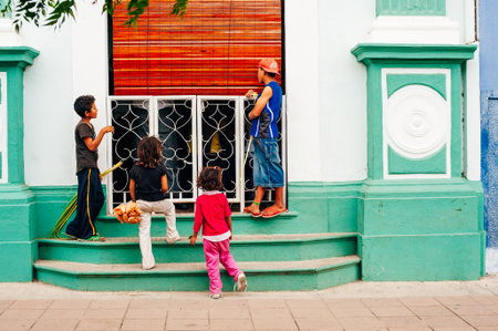 children watch rich people eat in a restaurant in Latin America. High quality photoのeditorial素材