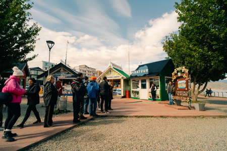 Ushuaia, Argentina - Dec 2th 2023 - many people in marine of Ushuaia, with the writings End of the World. High quality photoのeditorial素材