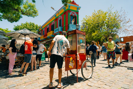 Typical brightly colored building on Caminito in La Boca witn tourists, Buenos Aires, Argentina - Dec 2th 2023. High quality photoのeditorial素材