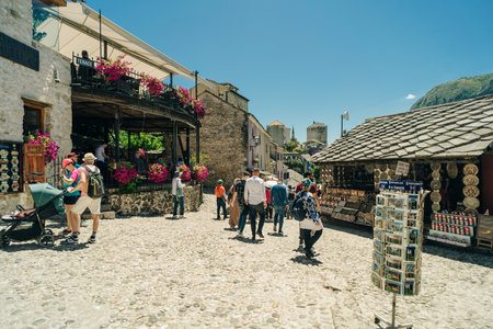 street with local shops and shoppers in Mostar, flanked by traditional architecture - July 10, 2024. High quality photoのeditorial素材