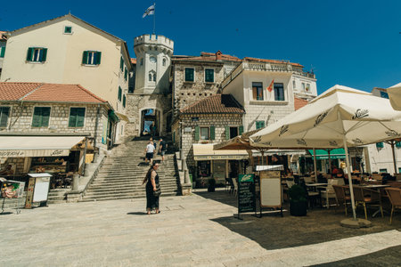 street with local shops and shoppers in Mostar, flanked by traditional architecture - July 10, 2024. High quality photoのeditorial素材
