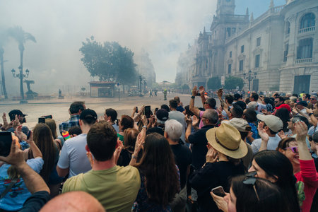 City hall square with fireworks exploding at Mascleta during the Las Fallas festival in Valencia Spain on March 2 2024. High quality photoのeditorial素材