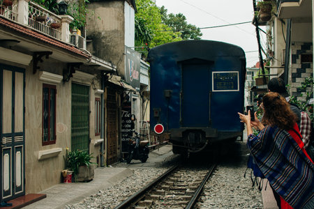 Hanoi, Vietnam - 24 May 2024 Tourists taking pictures of hurtling train. The Hanoi Train Street. High quality photoのeditorial素材
