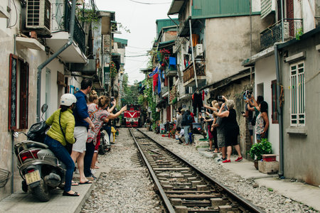Hanoi, Vietnam - 24 May 2024 Tourists taking pictures of hurtling train. The Hanoi Train Street. High quality photoのeditorial素材