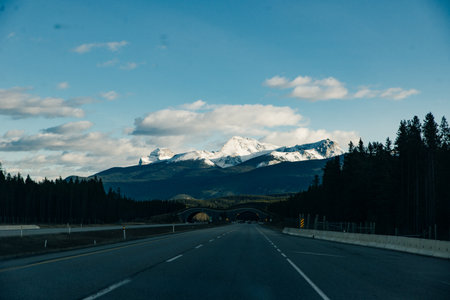 Scenic road through the Canadian Rockies, surrounded with rocky mountains. Taken in Banff National Park, Alberta, Canada.の写真素材