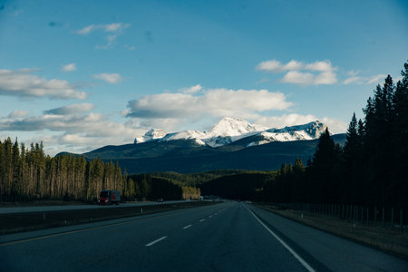 Scenic road through the Canadian Rockies, surrounded with rocky mountains. Taken in Banff National Park, Alberta, Canada.の写真素材