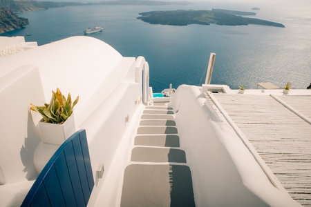 Gateway to rest. Santorini, Greece. Dawn of the sun, open doors and steps to the blue sea of Santorini island, Oia. Holidays in Greece, Santorini. European travel. High quality photoの写真素材