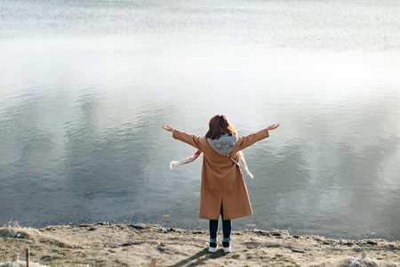 Hiker girl wrapping in warm clothes outdoor. Hiking in mountains in autumn. Bad weather with fog....