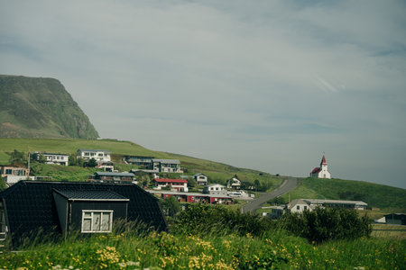 rural scene with grazing sheep, rustic farm buildings and a tranquil lake, capturing Iceland countryside charm.の写真素材