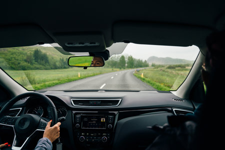 hands of car driver on steering wheel, road trip, driving on highway road. High quality photoの写真素材