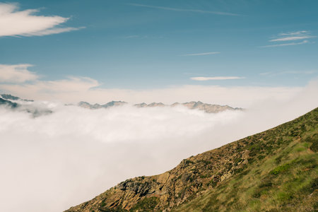 A breathtaking view of lush green hills unfolds, capturing the serenity of the French Pyrenees. High...