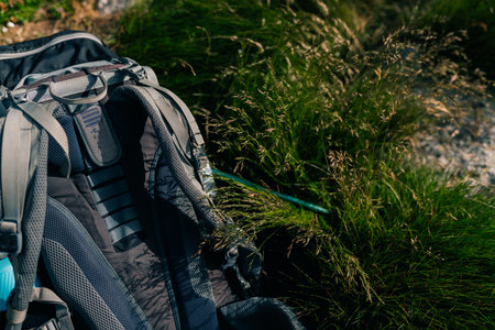 Tourist adventure backpack, packed hiking travel backpack stands on high hill against backdrop of...