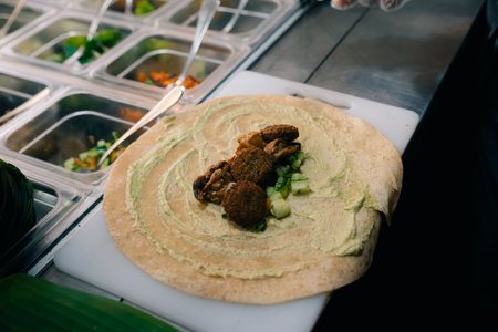 Chef making pita bread for falafel roll outdoor on street stall. High quality photoの写真素材
