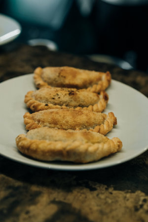 Delicious Argentine empanada with golden, crispy crust and flavorful meat filling. Perfect for...
