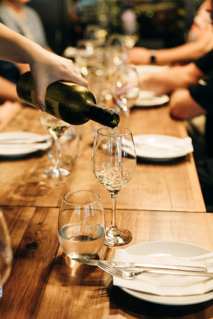 tableware Glasses, flower fork, knife served for dinner in restaurant with cozy interior. High quality photoの写真素材