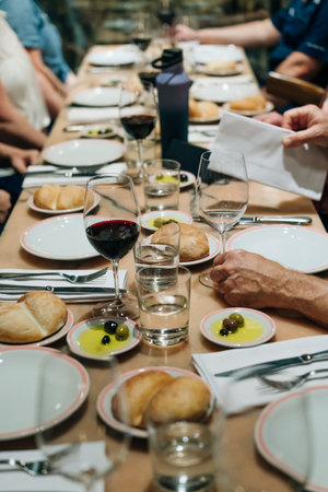 tableware Glasses, flower fork, knife served for dinner in restaurant with cozy interior. High quality photoの写真素材